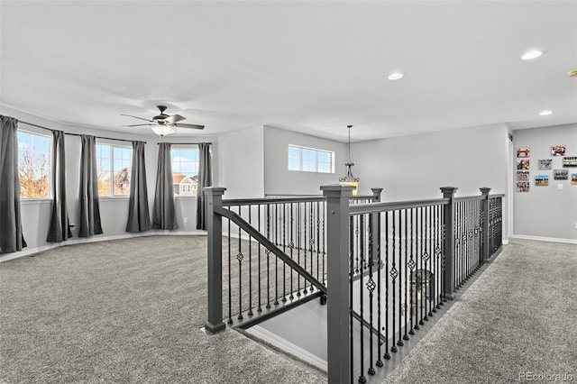 hallway featuring carpet and a healthy amount of sunlight