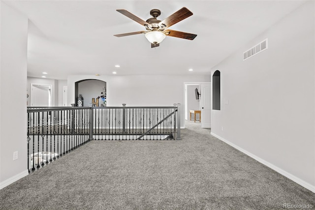 empty room with carpet flooring and ceiling fan