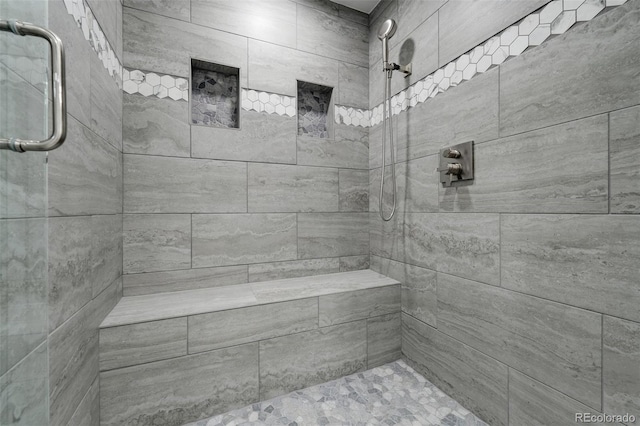 bathroom with a tile shower