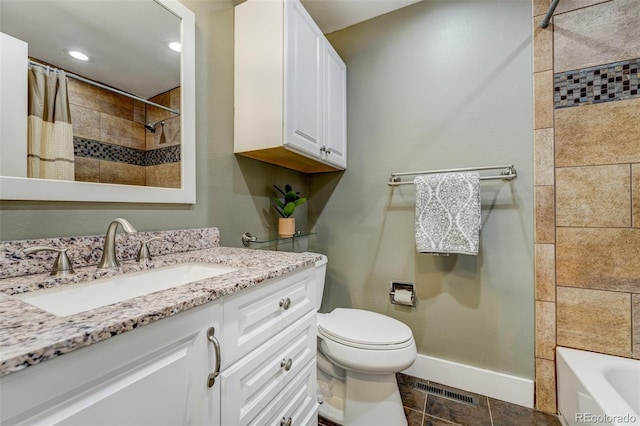 full bathroom with vanity, tiled shower / bath, and toilet