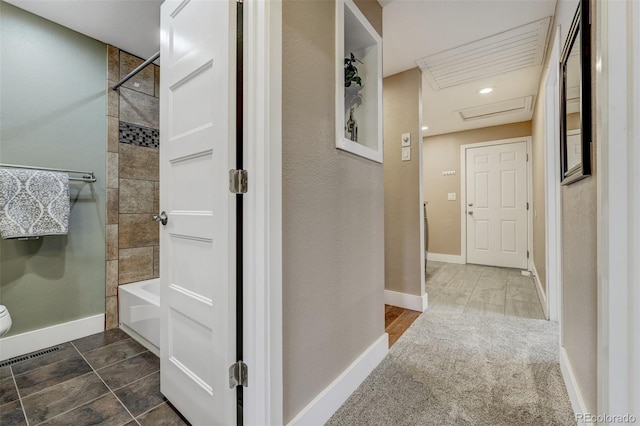 bathroom with toilet and tiled shower / bath combo