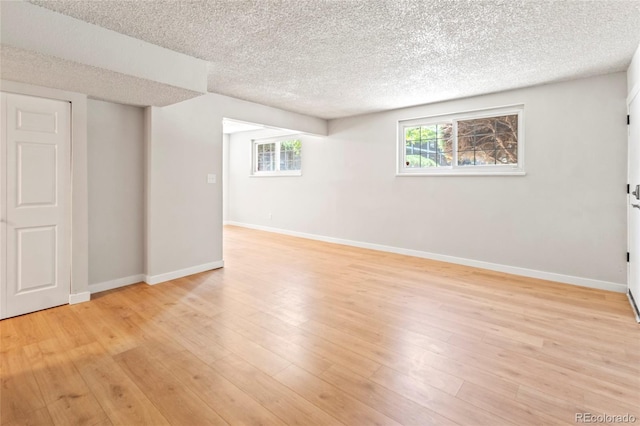 6800 E Tennessee Ave Unit 541, Denver, CO 80224 - basement with a textured ceiling, baseboards, and light wood-style floors