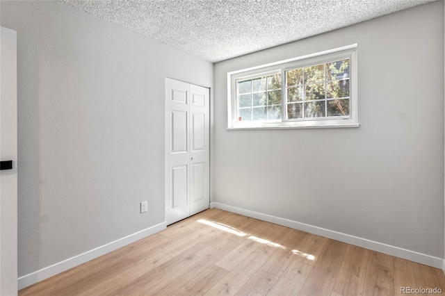 6800 E Tennessee Ave Unit 541, Denver, CO 80224 - spare room with wood finished floors, baseboards, and a textured ceiling