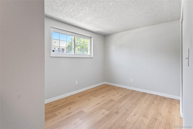 6800 E Tennessee Ave Unit 541, Denver, CO 80224 - empty room with light wood-style flooring, a textured ceiling, and baseboards