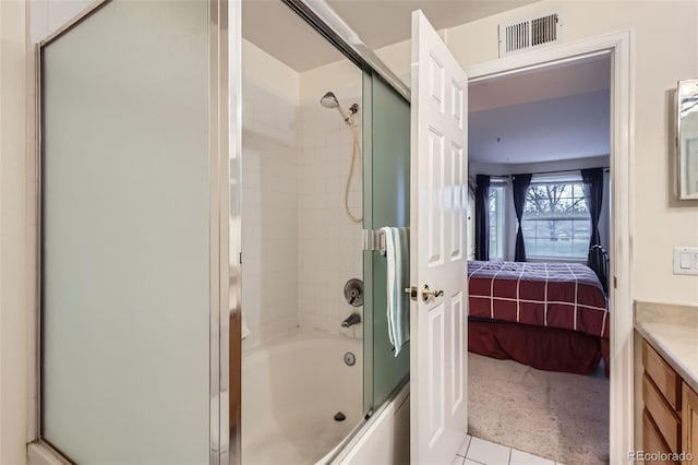 ensuite bathroom with enclosed tub / shower combo, visible vents, connected bathroom, and vanity