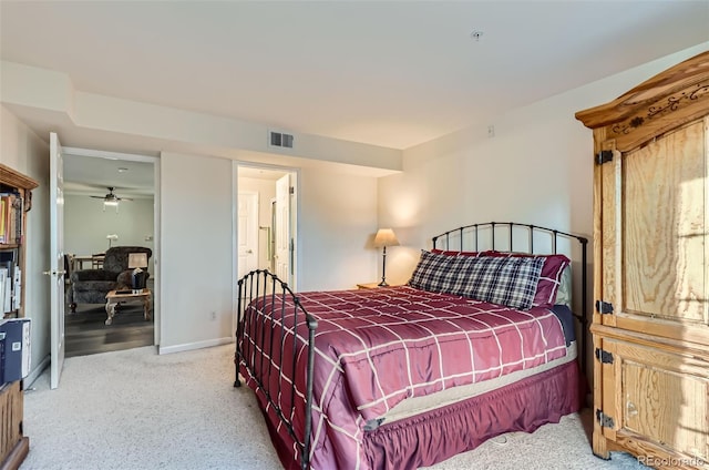 carpeted bedroom featuring baseboards and visible vents