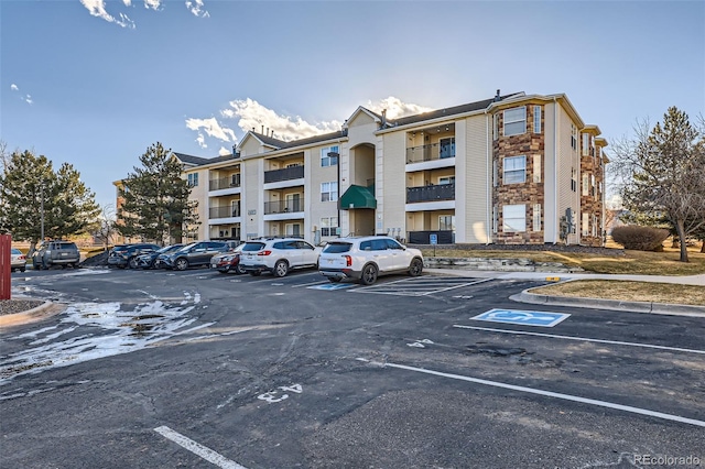 view of property featuring uncovered parking