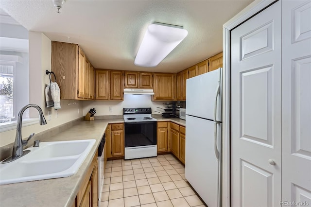 kitchen with electric stove, dishwashing machine, freestanding refrigerator, under cabinet range hood, and a sink