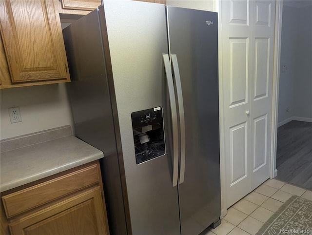 12338 W Dorado Pl Unit 107, Littleton, CO 80127 - details with brown cabinets, light countertops, and stainless steel refrigerator with ice dispenser
