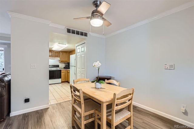 12338 W Dorado Pl Unit 107, Littleton, CO 80127 - dining room with ornamental molding, baseboards, a ceiling fan, and visible vents
