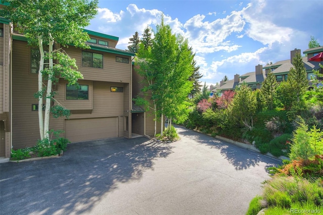 180 Nottingham Rd Unit C, Avon, CO 81620 - view of front of house with a garage, driveway, and a residential view
