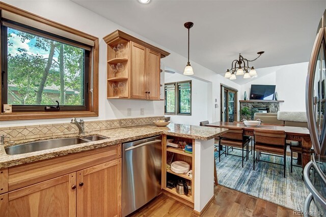 180 Nottingham Rd Unit C, Avon, CO 81620 - kitchen featuring stainless steel appliances, open shelves, healthy amount of natural light, and light stone countertops