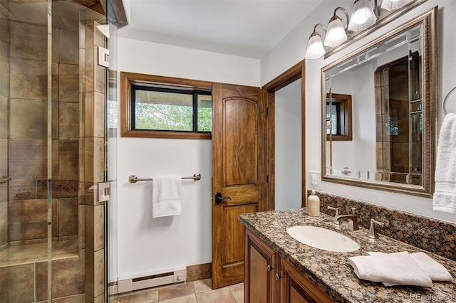 180 Nottingham Rd Unit C, Avon, CO 81620 - full bath featuring a baseboard radiator, vanity, a shower stall, and tile patterned flooring