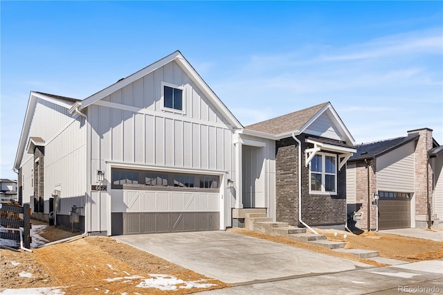modern farmhouse with a garage, board and batten siding, and concrete driveway