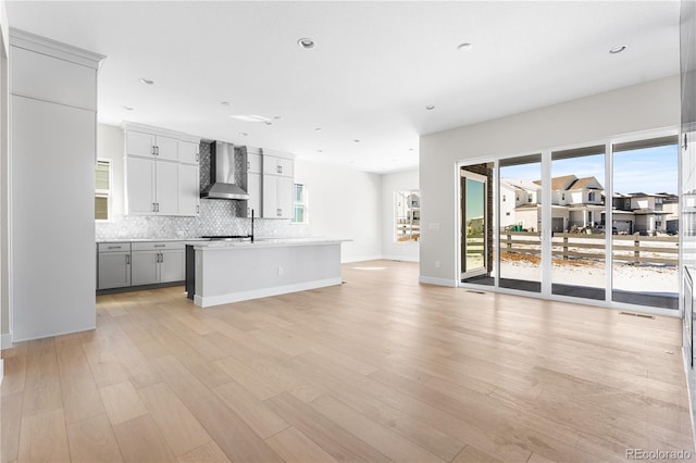 interior space with recessed lighting, baseboards, a sink, and light wood-style flooring