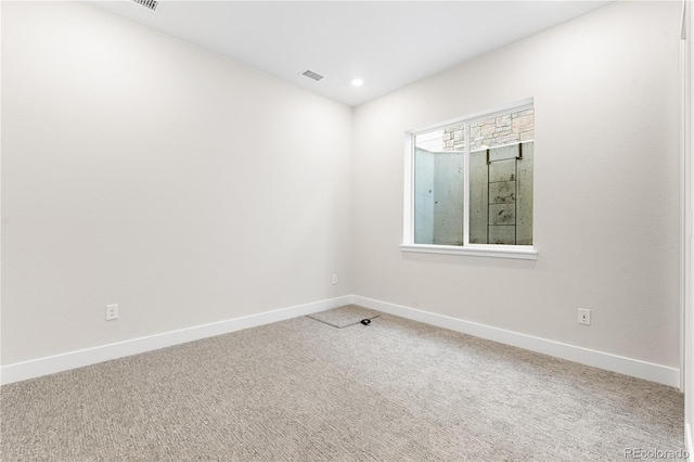 carpeted spare room with recessed lighting, baseboards, and visible vents