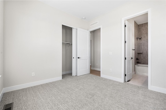 unfurnished bedroom featuring visible vents, baseboards, carpet floors, and a closet