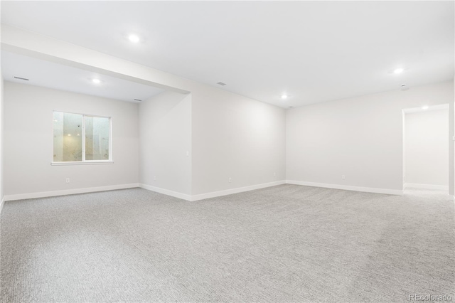 empty room with carpet flooring, recessed lighting, and baseboards