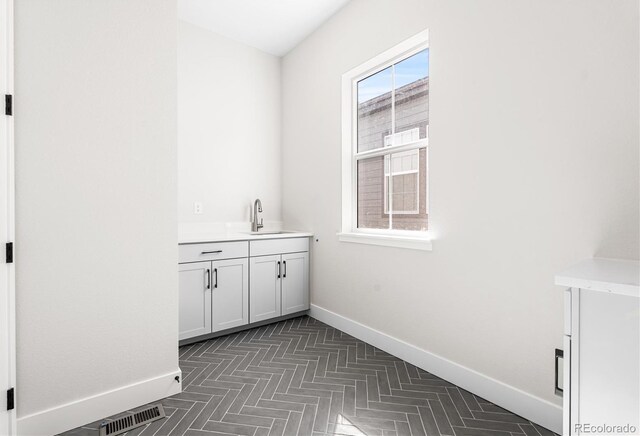 6675 Fawn Path Ln, Castle Pines, CO 80108 - interior space featuring baseboards, visible vents, and a sink