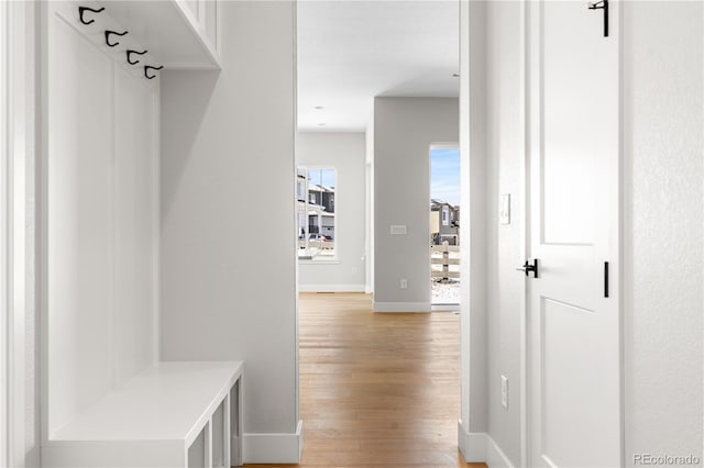mudroom with baseboards and light wood-style flooring
