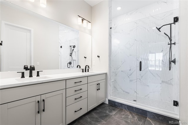 full bath featuring double vanity, a sink, marble finish floor, a marble finish shower, and recessed lighting