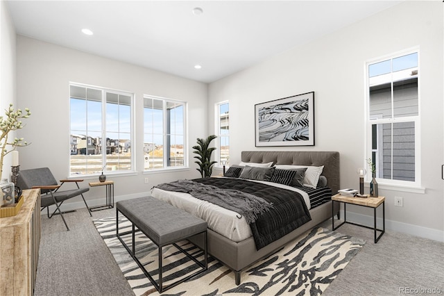 carpeted bedroom featuring recessed lighting and baseboards
