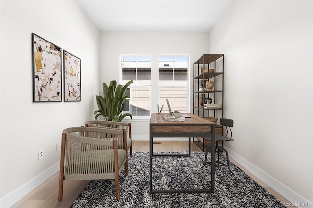office area featuring baseboards and wood finished floors