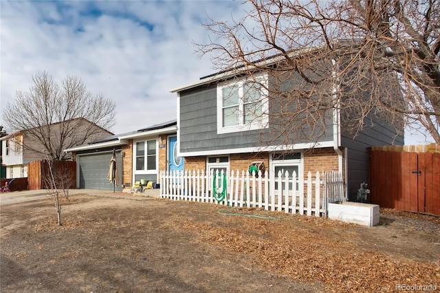 split level home featuring a garage and solar panels