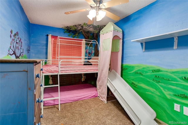 bedroom featuring carpet flooring, a textured ceiling, and ceiling fan