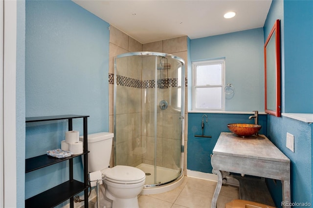 bathroom featuring walk in shower, sink, tile patterned floors, and toilet