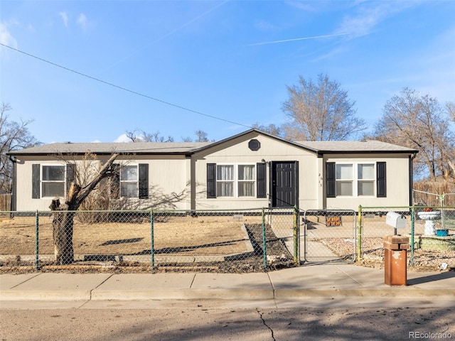 view of front of property with a fenced front yard and a gate