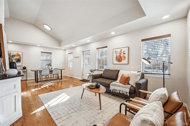 living area featuring vaulted ceiling, recessed lighting, light wood-type flooring, and baseboards