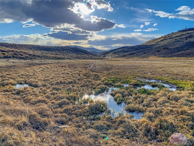 view of mountain feature with a water view