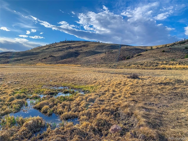 view of mountain feature with a water view