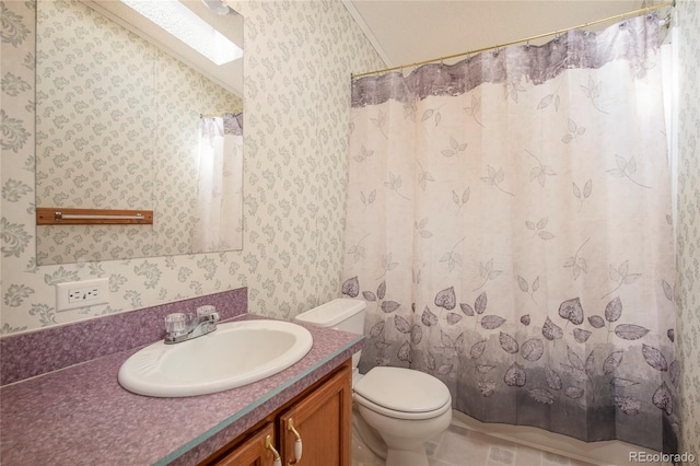 bathroom featuring toilet, tile flooring, vanity, and vaulted ceiling with skylight