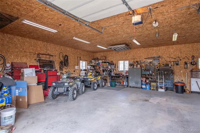 garage featuring a workshop area and a garage door opener