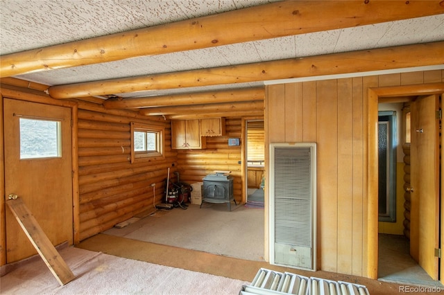 interior space with carpet and a wood stove