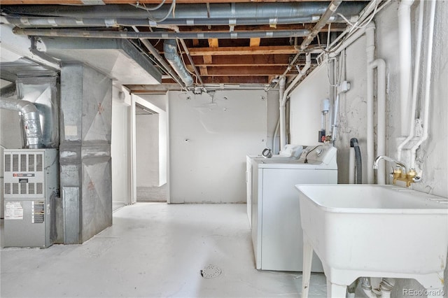 unfinished basement with heating unit, washing machine and dryer, and a sink