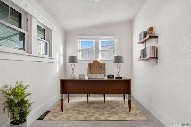 carpeted office with vaulted ceiling, a textured ceiling, and baseboards