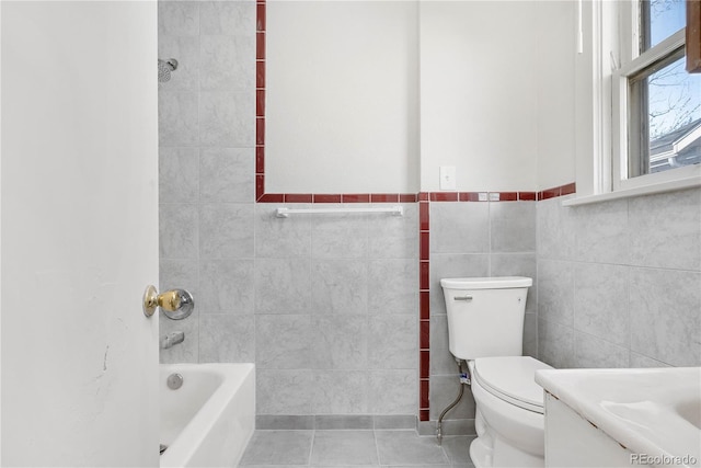 bathroom with vanity, tile walls, toilet, and tile patterned floors