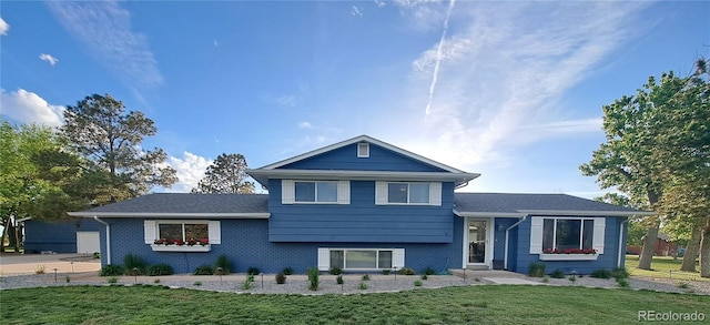 15945 Delta Ct, Brighton, CO 80603 - tri-level home featuring a front lawn and brick siding