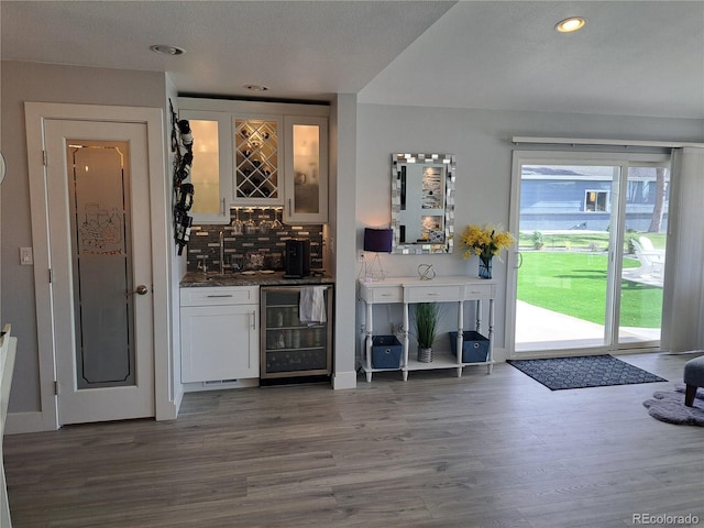 15945 Delta Ct, Brighton, CO 80603 - indoor dry bar with wine cooler, tasteful backsplash, wood finished floors, and recessed lighting