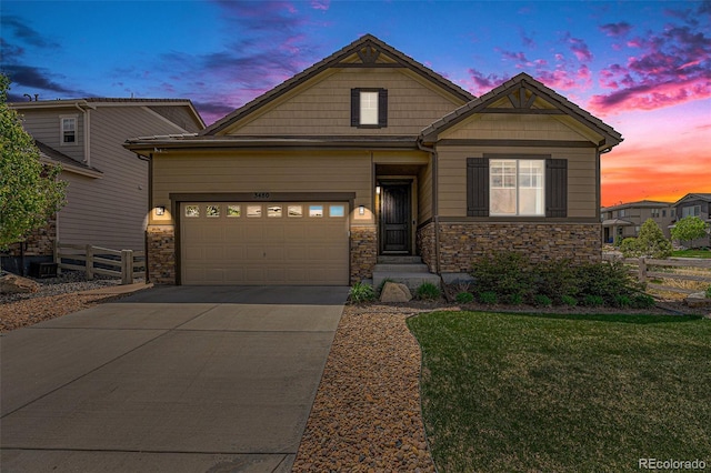 3480 Mount Powell Dr, Broomfield, CO 80023 - craftsman inspired home with a yard, a garage, fence, concrete driveway, and stone siding