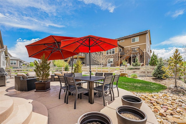 3480 Mount Powell Dr, Broomfield, CO 80023 - view of patio featuring fence, grilling area, outdoor dining area, stairs, and a residential view