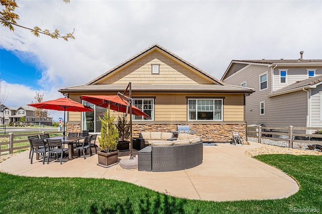 3480 Mount Powell Dr, Broomfield, CO 80023 - back of house with an outdoor living space, a lawn, fence, a patio, and stone siding