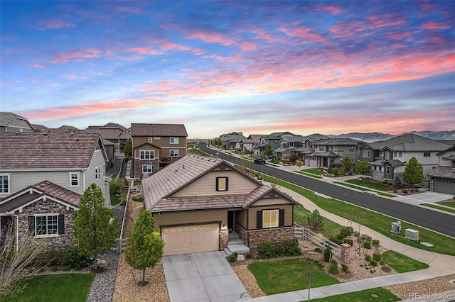 3480 Mount Powell Dr, Broomfield, CO 80023 - view of front of house with a residential view, cooling unit, concrete driveway, an attached garage, and stone siding