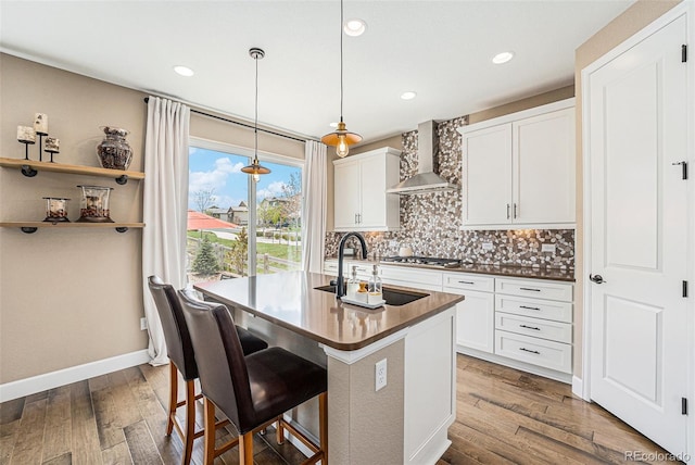 3480 Mount Powell Dr, Broomfield, CO 80023 - kitchen featuring dark wood-style flooring, decorative backsplash, a sink, and wall chimney exhaust hood