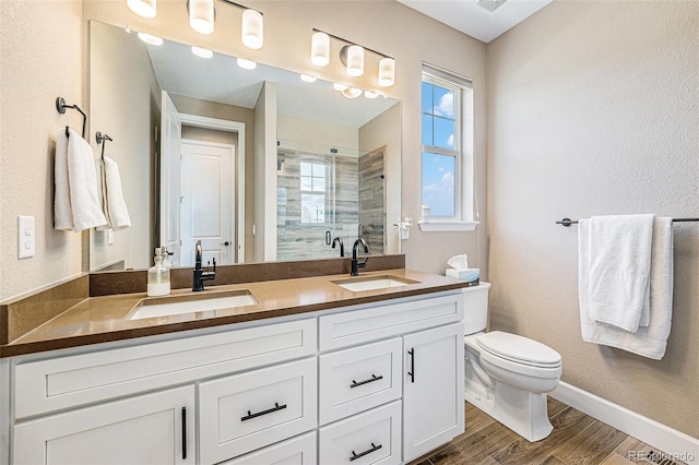 3480 Mount Powell Dr, Broomfield, CO 80023 - bathroom featuring double vanity, a sink, a stall shower, and wood finished floors