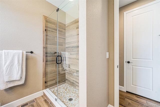 3480 Mount Powell Dr, Broomfield, CO 80023 - bathroom with baseboards, a shower stall, and wood finished floors