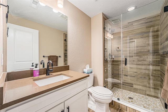 3480 Mount Powell Dr, Broomfield, CO 80023 - bathroom with a textured wall, vanity, toilet, a textured ceiling, and a shower stall